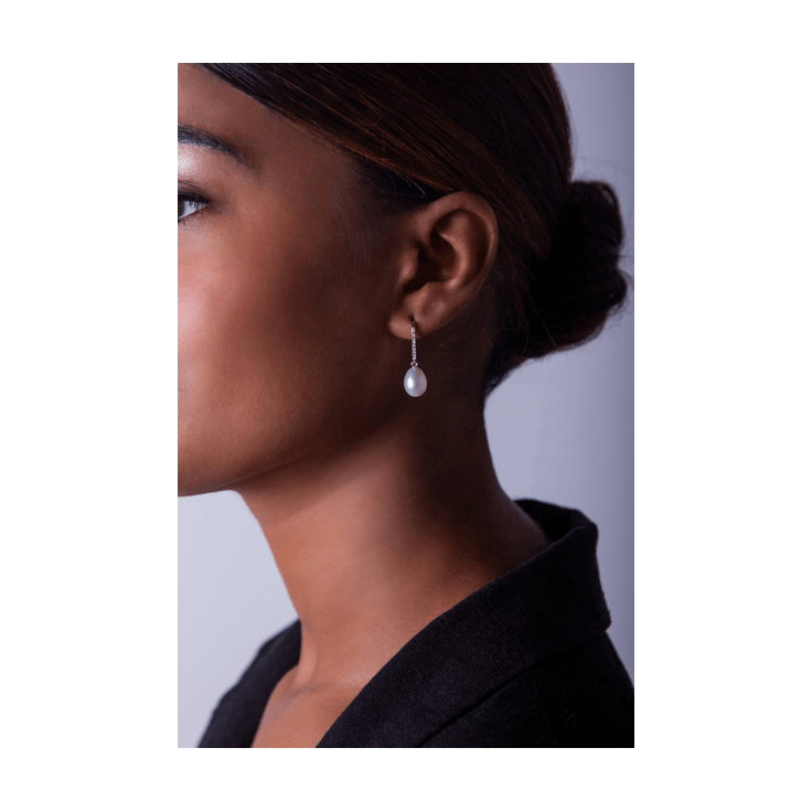Diamond Pearl Drop Earrings on woman